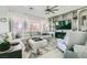 Bright living room with plush seating, large windows, and elegant built-in shelving at 10408 Mezzanino Ct, Las Vegas, NV 89135