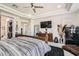 Bright main bedroom features a king bed, ceiling fan, and a secure FORT KNOX safe for added peace of mind at 10408 Mezzanino Ct, Las Vegas, NV 89135