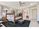Inviting bedroom features a ceiling fan, stylish accent wall, and a cozy seating area at 10408 Mezzanino Ct, Las Vegas, NV 89135