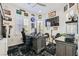 Well-lit home office with a large desk, comfortable chair, and decorative automotive-themed accents at 10408 Mezzanino Ct, Las Vegas, NV 89135