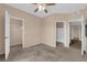 Spacious bedroom with neutral walls, ceiling fan, and carpeted floors at 10550 W Alexander Rd # 2233, Las Vegas, NV 89129