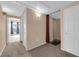 Hallway with multiple doorways, neutral carpeting, and sconce lighting at 10550 W Alexander Rd # 2233, Las Vegas, NV 89129