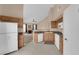 Open kitchen features white appliances and cabinetry flowing into adjacent living space at 10550 W Alexander Rd # 2233, Las Vegas, NV 89129