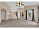 Open living room with neutral tones, ceiling fan, and access to outdoor space at 10550 W Alexander Rd # 2233, Las Vegas, NV 89129