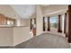 Cozy living room featuring neutral carpeting, plentiful windows and adjacent kitchen area at 10550 W Alexander Rd # 2233, Las Vegas, NV 89129
