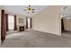 Inviting living room with a fireplace, ceiling fan, and neutral carpeting at 10550 W Alexander Rd # 2233, Las Vegas, NV 89129