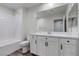 Bathroom featuring vanity with white cabinets, sink and modern fixtures, plus a toilet and shower-tub combo at 10777 Briset Ct, Las Vegas, NV 89166