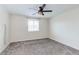 This bedroom features neutral walls, carpet flooring, and a ceiling fan at 10777 Briset Ct, Las Vegas, NV 89166