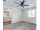 This bedroom features neutral walls, carpet flooring, a ceiling fan, and an attached bathroom at 10777 Briset Ct, Las Vegas, NV 89166