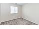 Bright carpeted bedroom with a large window offering natural light, neutral walls, and electrical outlets at 10777 Briset Ct, Las Vegas, NV 89166