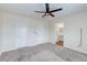 This bedroom features neutral walls, carpet flooring, a ceiling fan, and two doors at 10777 Briset Ct, Las Vegas, NV 89166