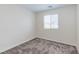 Carpeted bedroom with window, white walls, baseboards, and electrical outlets ready for furniture arrangement at 10777 Briset Ct, Las Vegas, NV 89166