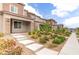 Beautifully landscaped front exterior of a modern home with walkway and manicured garden beds at 10777 Briset Ct, Las Vegas, NV 89166