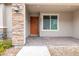Inviting front porch with stone accents, brick pavers and a dark wood front door at 10777 Briset Ct, Las Vegas, NV 89166