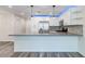 This kitchen features a breakfast bar, recessed lighting, stainless steel appliances, and floating shelves at 10777 Briset Ct, Las Vegas, NV 89166
