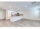 Open-concept kitchen with stainless steel appliances, quartz countertops, and modern pendant lighting at 10777 Briset Ct, Las Vegas, NV 89166