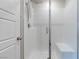 Tiled walk-in shower featuring a shower head, chrome fixtures, a glass door and a built-in bench at 10777 Briset Ct, Las Vegas, NV 89166