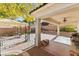Covered outdoor patio with a ceiling fan and desert landscaping for relaxing and entertaining at 11132 Ferragamo Ct, Las Vegas, NV 89141