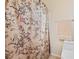 Bathroom with a patterned shower curtain, neutral paint, and a tiled floor at 11132 Ferragamo Ct, Las Vegas, NV 89141