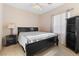 Calm bedroom with a dark wood sleigh bed and black bookcase at 11132 Ferragamo Ct, Las Vegas, NV 89141
