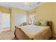 Comfortable bedroom with a ceiling fan, carpet flooring, and a window providing natural light at 11132 Ferragamo Ct, Las Vegas, NV 89141