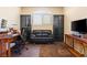 Comfortable home office featuring a desk, comfy leather sofa, and storage at 11132 Ferragamo Ct, Las Vegas, NV 89141