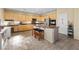 Open kitchen featuring an island, tile flooring, stainless steel appliances, and lots of cabinet space at 11132 Ferragamo Ct, Las Vegas, NV 89141