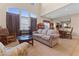 Bright and airy living room with high ceilings, large windows, and an open layout to the dining area at 11132 Ferragamo Ct, Las Vegas, NV 89141