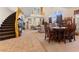 Open-concept living space with a staircase, living room, dining area, and entryway, creating a harmonious flow at 11132 Ferragamo Ct, Las Vegas, NV 89141