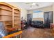 Home office featuring a comfortable leather sofa, built in bookcase and a large window at 11132 Ferragamo Ct, Las Vegas, NV 89141
