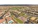 An aerial view of a Primary-planned community, with lush landscaping and well-maintained homes, and a nearby golf course at 12048 Portamento Ct, Las Vegas, NV 89138