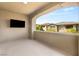 Cozy balcony with an outdoor television, offering a view of neighboring homes and blue skies at 12048 Portamento Ct, Las Vegas, NV 89138