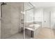Modern bathroom featuring a glass-enclosed shower, a separate soaking tub, and neutral tile, creating a serene atmosphere at 12048 Portamento Ct, Las Vegas, NV 89138