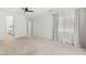 Large bedroom with plush carpet flooring and sheer curtains, leading to an ensuite bathroom, creating a private retreat at 12048 Portamento Ct, Las Vegas, NV 89138