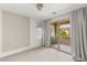Bright bedroom with a sliding glass door to a balcony, complemented by stylish curtains at 12048 Portamento Ct, Las Vegas, NV 89138