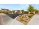 Well-maintained community entrance with lush landscaping and decorative brick accents at 12048 Portamento Ct, Las Vegas, NV 89138