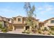 Stunning two-story home with beautiful landscaping, a neutral color palette, and inviting curb appeal at 12048 Portamento Ct, Las Vegas, NV 89138