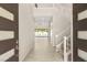 Welcoming foyer showcasing a grand staircase and a view of the backyard oasis through the living area at 12048 Portamento Ct, Las Vegas, NV 89138