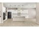 Modern kitchen featuring sleek white cabinetry, stainless steel appliances, and a spacious center island at 12048 Portamento Ct, Las Vegas, NV 89138