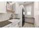 Well-lit laundry room with modern appliances and plenty of counter space at 12048 Portamento Ct, Las Vegas, NV 89138