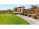 Landscaped entrance to Allegra neighborhood showing manicured lawn and brick sign at 12048 Portamento Ct, Las Vegas, NV 89138