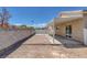 This backyard features a covered patio area, brick trim, and block wall at 1213 Star Meadow Dr, North Las Vegas, NV 89030
