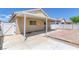 This backyard features a covered patio area, a white gate, and brick trim at 1213 Star Meadow Dr, North Las Vegas, NV 89030