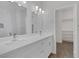 Modern bathroom featuring a double vanity with stone countertops and an entrance to the walk-in closet at 1213 Star Meadow Dr, North Las Vegas, NV 89030