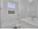 Well-lit bathroom showcasing a shower-tub combo with white marble tiling and sleek fixtures at 1213 Star Meadow Dr, North Las Vegas, NV 89030