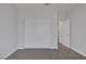 Bedroom with neutral carpet, closet doors, and a door to another room at 1213 Star Meadow Dr, North Las Vegas, NV 89030