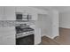 Well-appointed kitchen with stainless steel appliances, white cabinetry, and designer backsplash at 1213 Star Meadow Dr, North Las Vegas, NV 89030