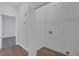 Laundry room with ample space for washer/dryer, wire shelving, and hardwood-style floors at 1213 Star Meadow Dr, North Las Vegas, NV 89030