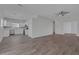 Open living space with wood-look flooring leading to a bright kitchen with white cabinets at 1213 Star Meadow Dr, North Las Vegas, NV 89030