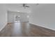 Open living room with wood floors, ceiling fan, and sliding glass door at 1213 Star Meadow Dr, North Las Vegas, NV 89030